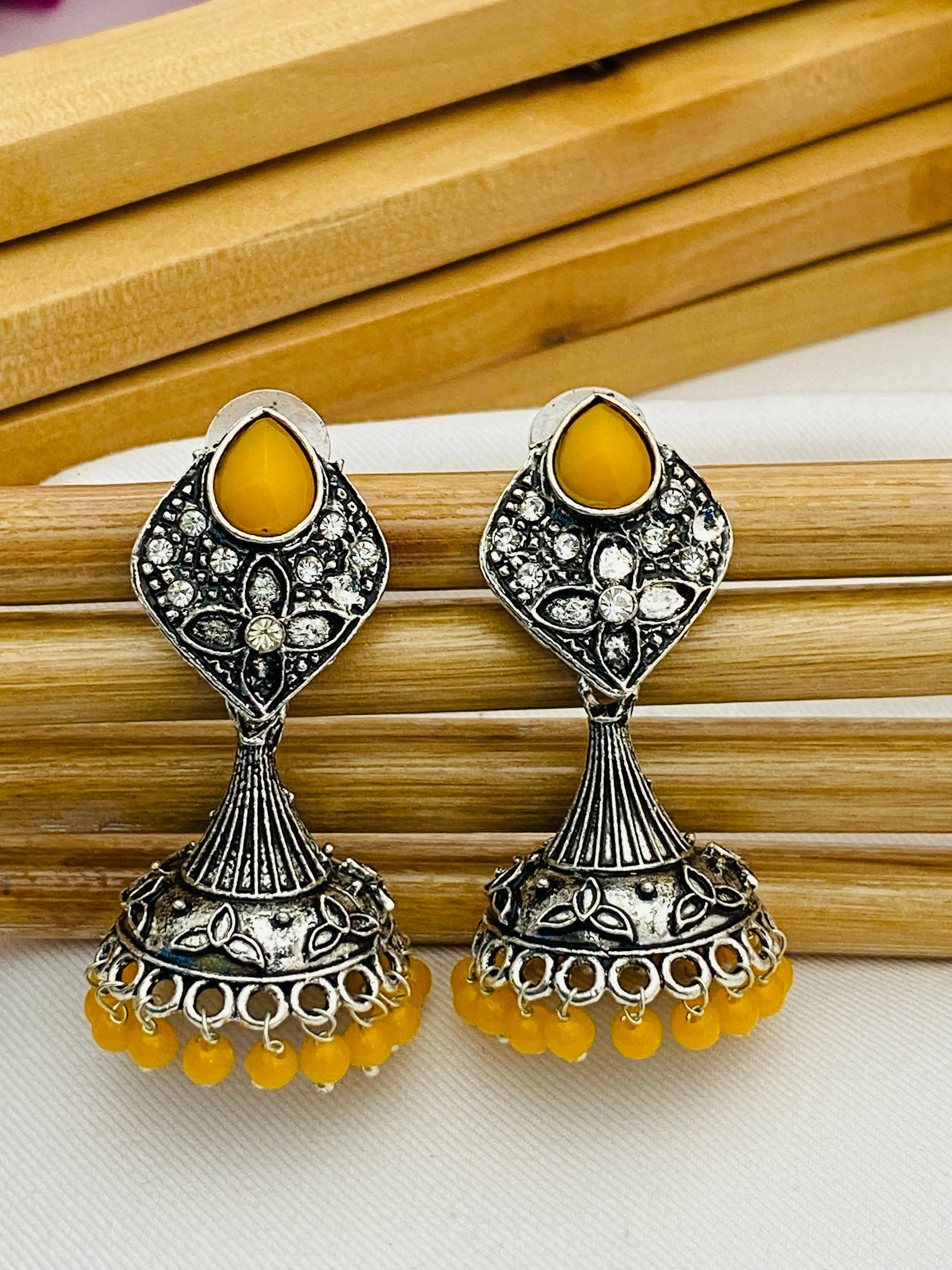 Elegant Yellow Color Stone Beaded Flower Designer Silver Toned Oxidized Jhumka Earrings With Beads